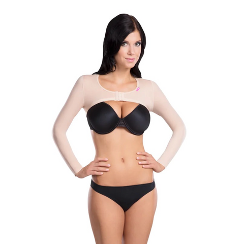 Woman wearing a black bra and panties set with a beige long-sleeve top on a white background