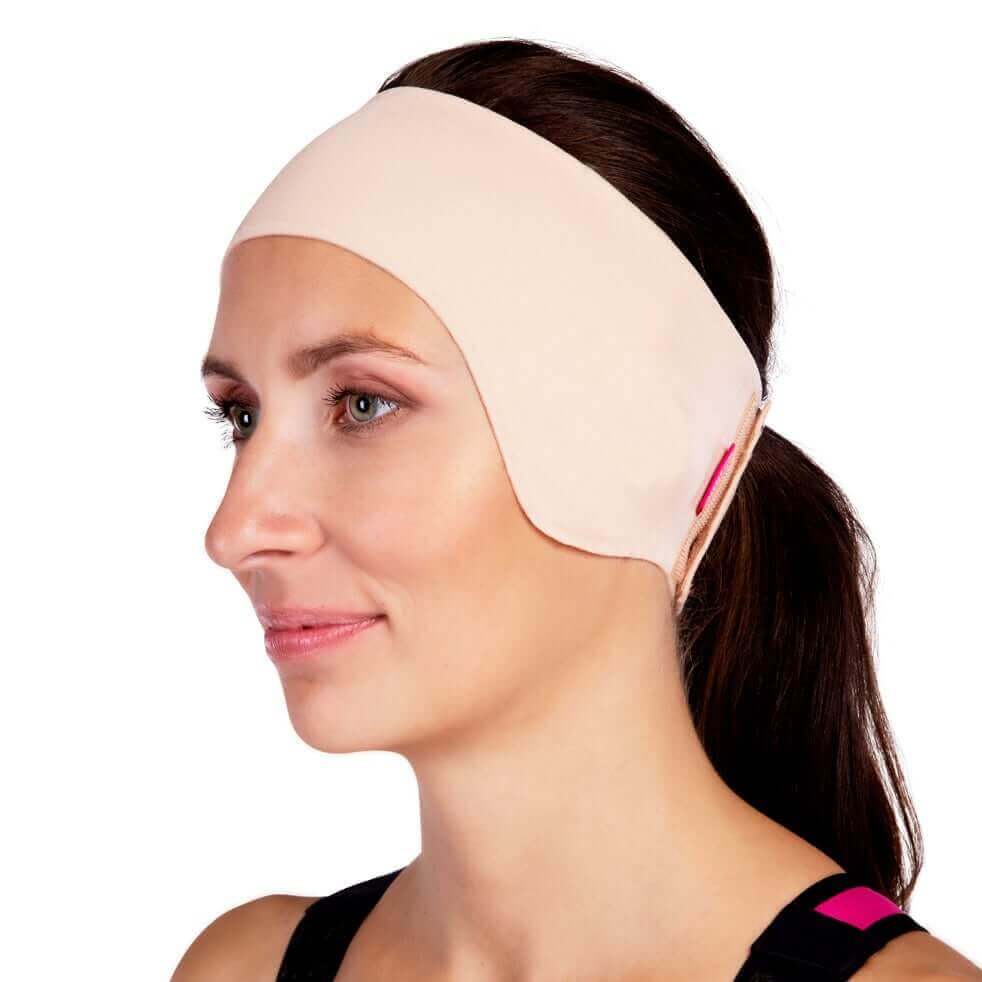beige compression headband covering ears